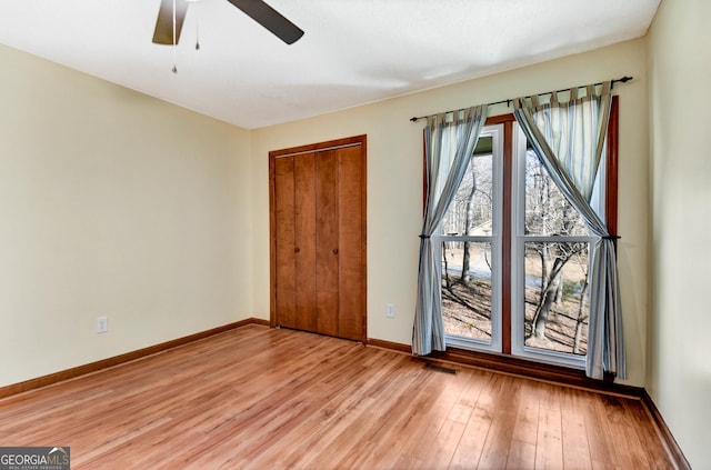 unfurnished bedroom with ceiling fan, visible vents, baseboards, a closet, and light wood finished floors