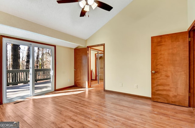 unfurnished bedroom with high vaulted ceiling, light wood-style flooring, visible vents, baseboards, and access to exterior