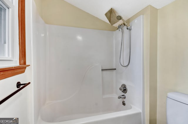 bathroom featuring shower / washtub combination and toilet