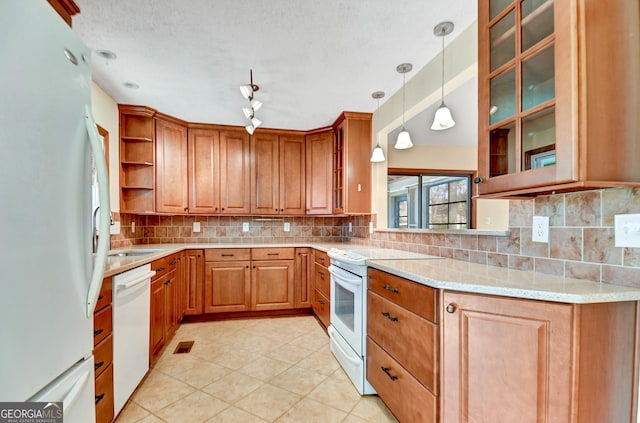 kitchen featuring white appliances, decorative backsplash, glass insert cabinets, light stone counters, and open shelves