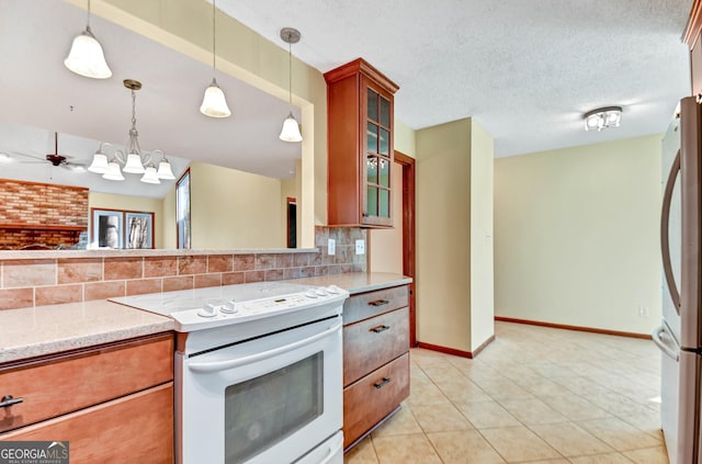 kitchen with electric stove, brown cabinets, freestanding refrigerator, a textured ceiling, and backsplash