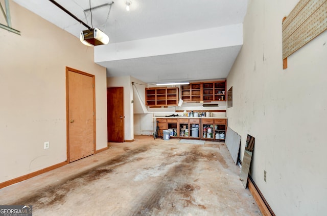 garage featuring baseboards and a garage door opener