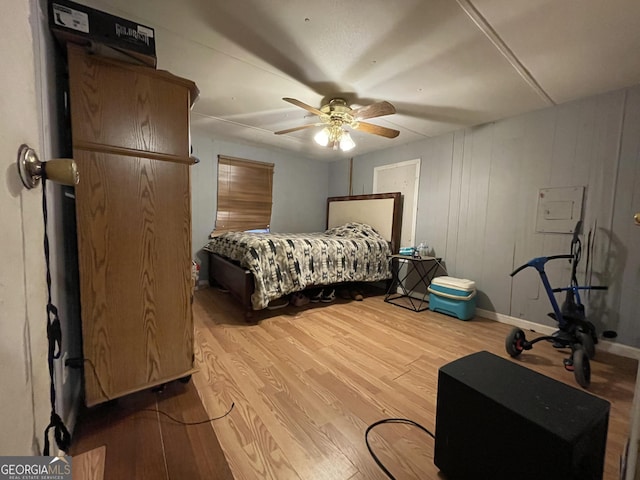 bedroom with wood finished floors, a ceiling fan, and baseboards