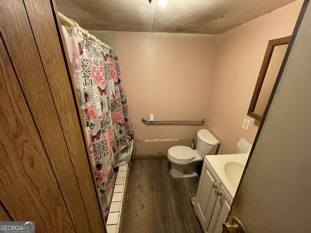 full bathroom featuring toilet, curtained shower, wood finished floors, and vanity