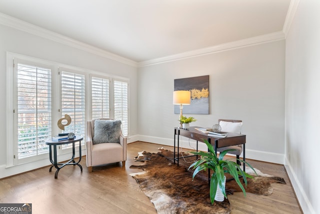 home office featuring a healthy amount of sunlight, ornamental molding, and wood finished floors