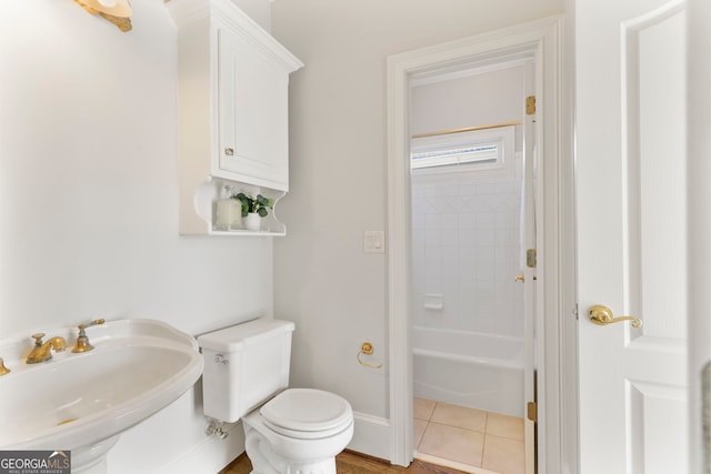 bathroom featuring tile patterned flooring, a sink, toilet, and baseboards