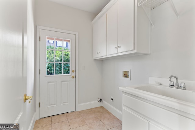 laundry room featuring light tile patterned floors, washer hookup, baseboards, cabinet space, and electric dryer hookup