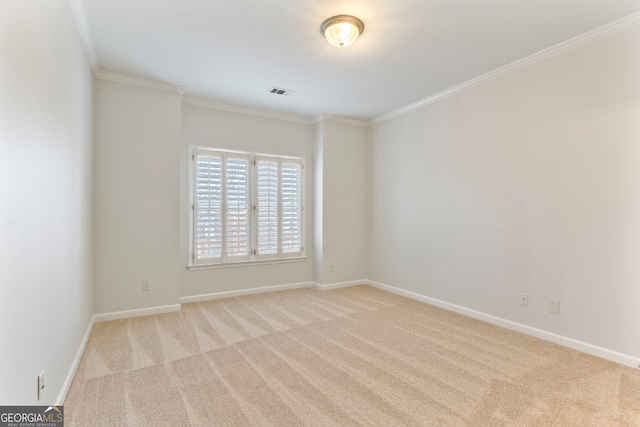 empty room featuring carpet floors, visible vents, ornamental molding, and baseboards