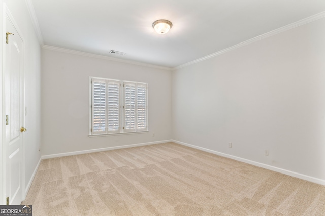 empty room with baseboards, visible vents, ornamental molding, and light colored carpet