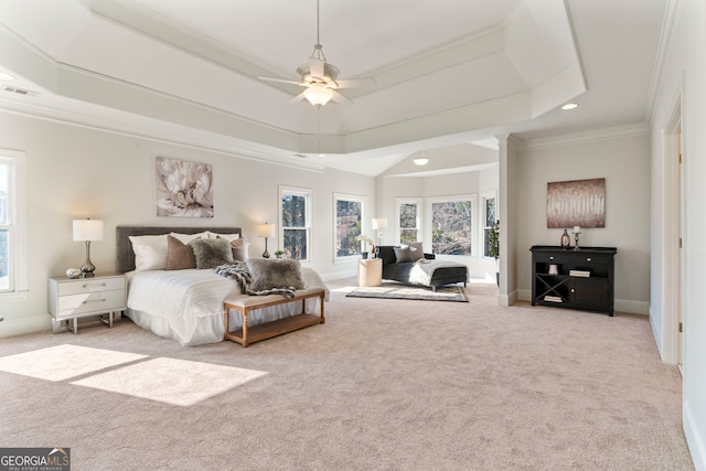 bedroom featuring ornamental molding, a tray ceiling, carpet flooring, and visible vents