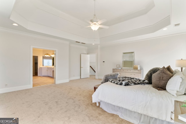 bedroom featuring light colored carpet, visible vents, baseboards, ornamental molding, and a tray ceiling