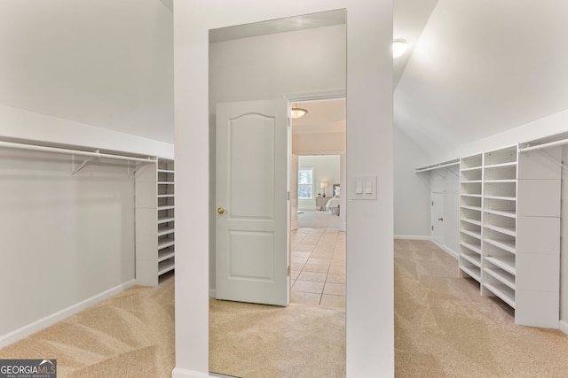 spacious closet with carpet floors and tile patterned flooring