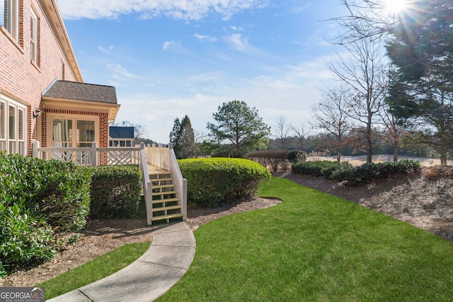 view of yard with stairway and a deck