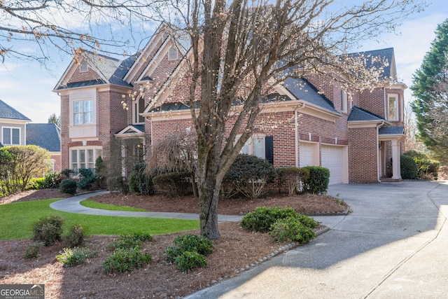 view of front of property featuring a garage, concrete driveway, and brick siding