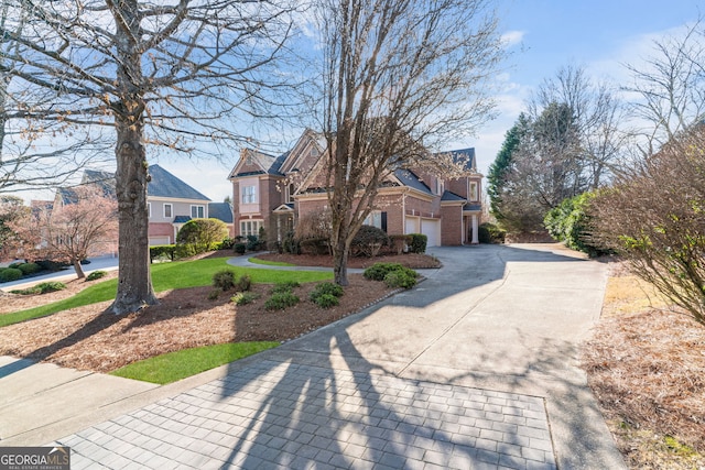 traditional home with concrete driveway and brick siding