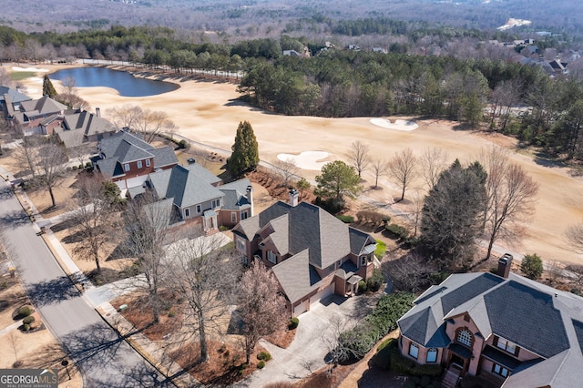 bird's eye view with a water view, a wooded view, and a residential view