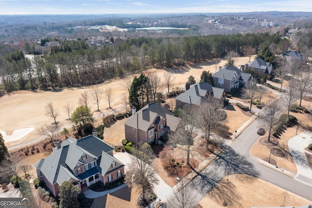 birds eye view of property with a residential view and a wooded view