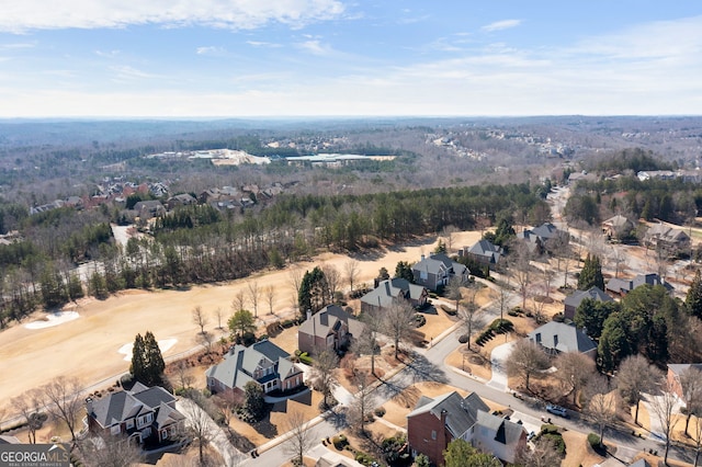 aerial view featuring a wooded view and a residential view