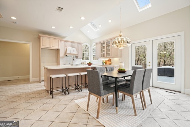 dining space with light tile patterned floors, recessed lighting, a skylight, visible vents, and baseboards