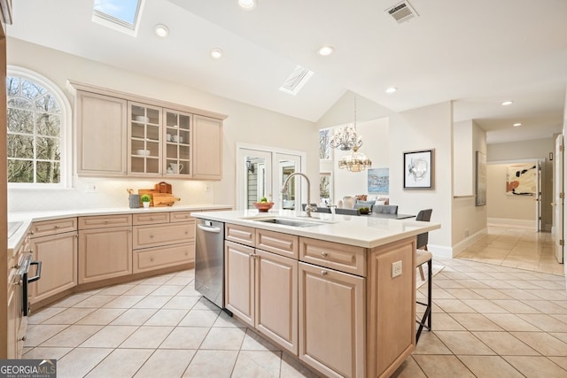 kitchen featuring light tile patterned flooring, a sink, visible vents, and light brown cabinetry