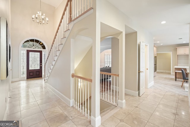 foyer featuring a chandelier, recessed lighting, baseboards, and light tile patterned floors