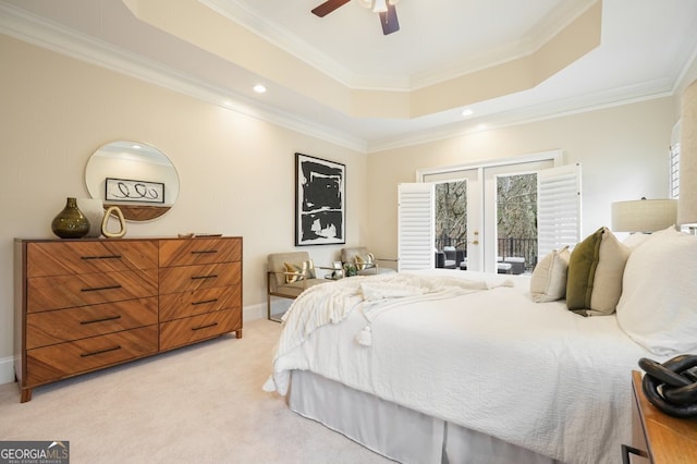 bedroom with a raised ceiling, light colored carpet, access to outside, crown molding, and french doors