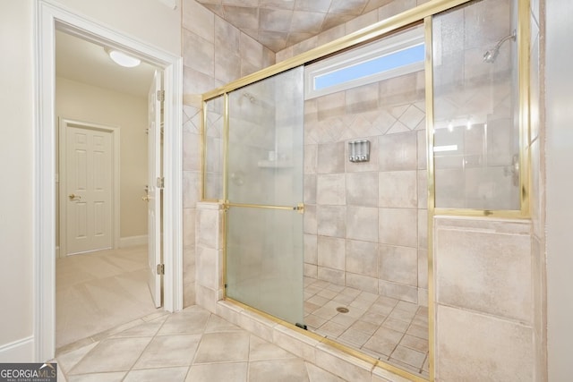 full bath featuring tile patterned flooring and tiled shower