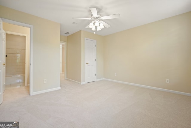 unfurnished bedroom featuring baseboards, ceiling fan, visible vents, and light colored carpet