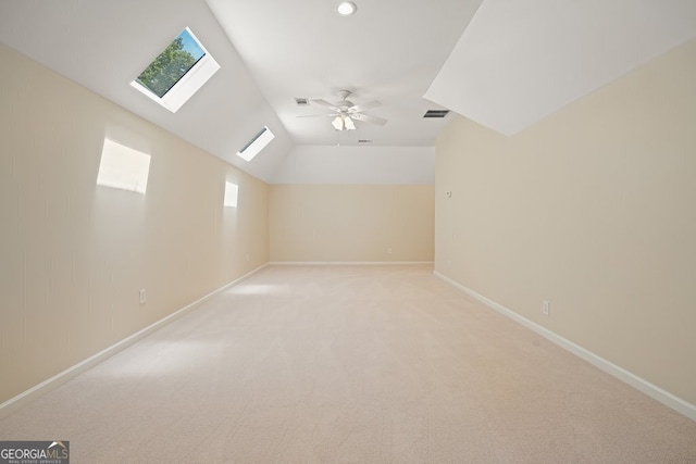 bonus room featuring visible vents, baseboards, light colored carpet, lofted ceiling, and ceiling fan