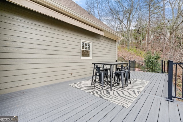 wooden terrace featuring outdoor dining area