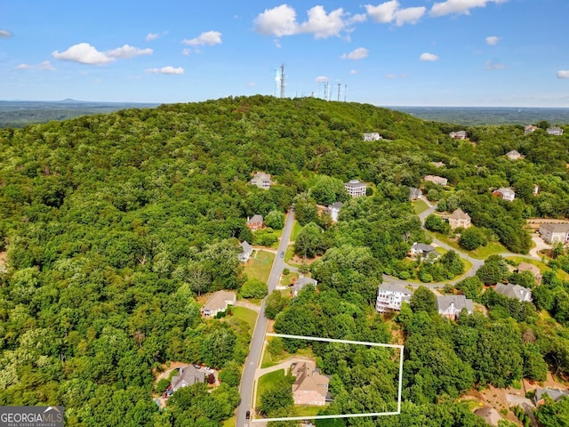 birds eye view of property featuring a view of trees