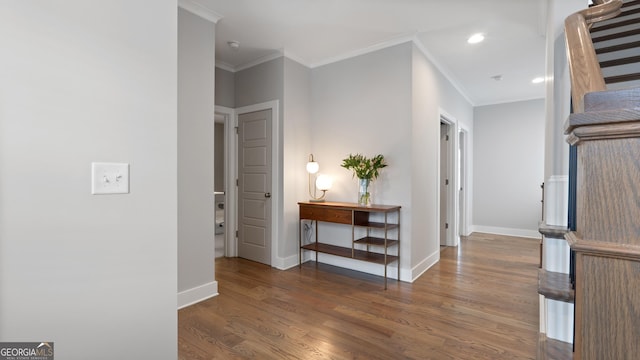 hallway featuring recessed lighting, crown molding, baseboards, and wood finished floors