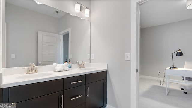 bathroom featuring visible vents, a sink, baseboards, and double vanity