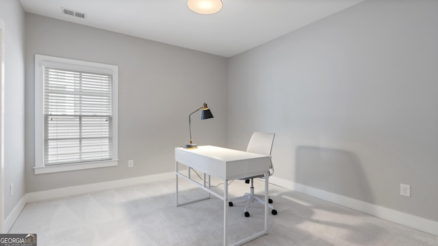 office space featuring carpet floors, baseboards, and visible vents