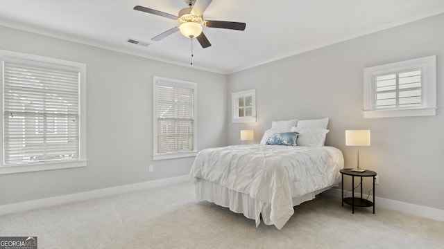 carpeted bedroom with baseboards, visible vents, and a ceiling fan