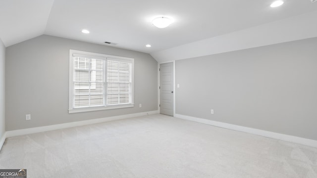 additional living space featuring lofted ceiling, recessed lighting, visible vents, baseboards, and carpet