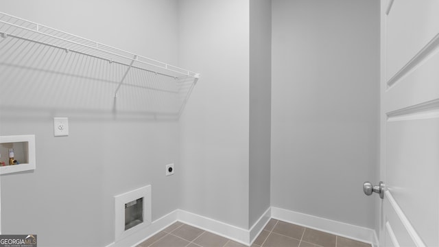 washroom with laundry area, dark tile patterned flooring, washer hookup, baseboards, and electric dryer hookup