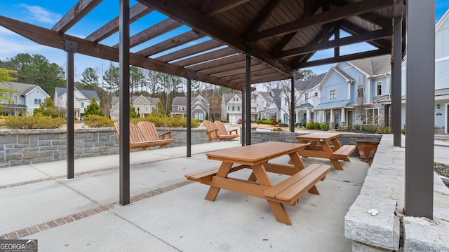 view of patio featuring a residential view and a pergola