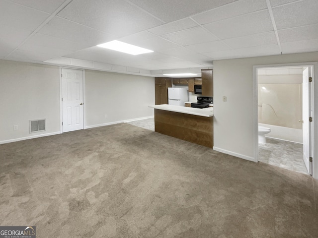 unfurnished living room with carpet floors, a paneled ceiling, visible vents, and baseboards