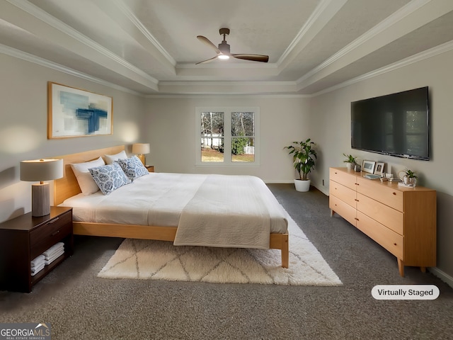 bedroom featuring a raised ceiling, dark carpet, ornamental molding, ceiling fan, and baseboards