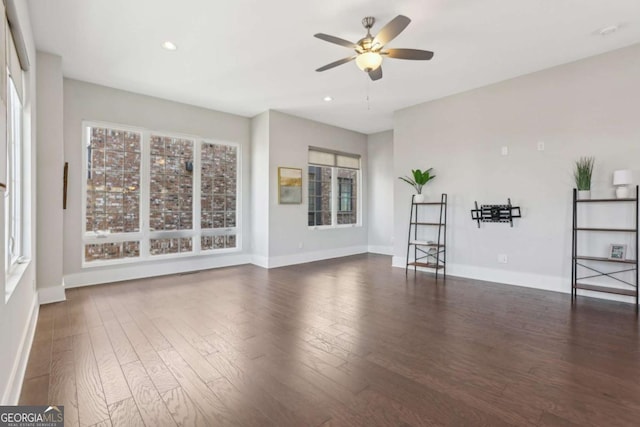 unfurnished living room featuring ceiling fan, recessed lighting, wood finished floors, and baseboards