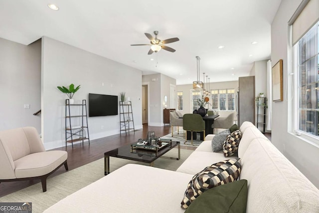 living room featuring recessed lighting, ceiling fan, baseboards, and wood finished floors