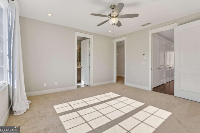 unfurnished bedroom with baseboards, visible vents, connected bathroom, carpet flooring, and recessed lighting