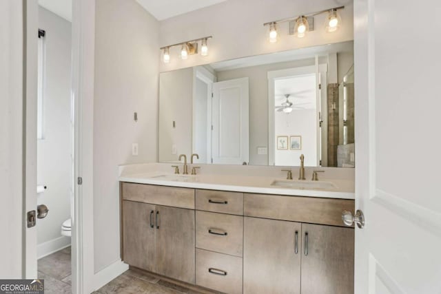 full bath with double vanity, tile patterned flooring, a sink, and toilet