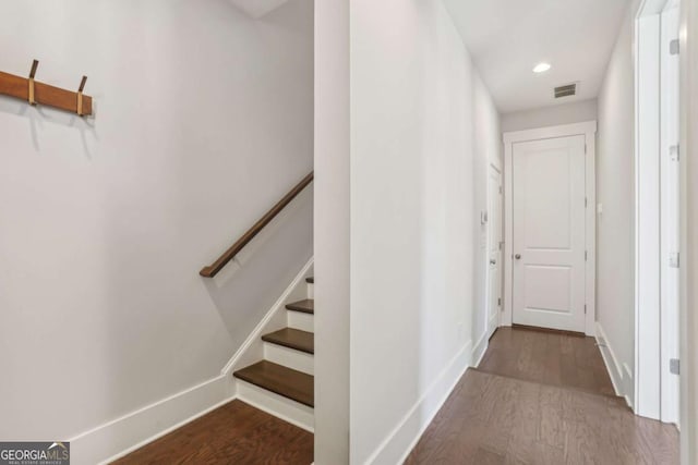 stairs with baseboards, visible vents, wood finished floors, and recessed lighting