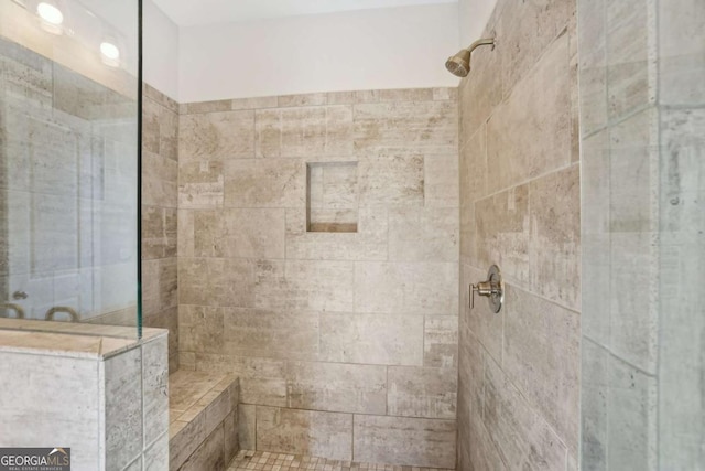 full bath featuring a tile shower