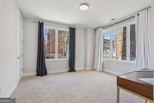 interior space with carpet floors, visible vents, and baseboards