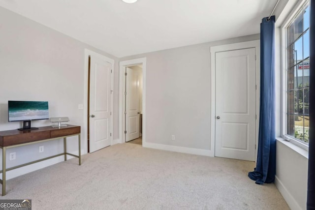 interior space featuring carpet and baseboards