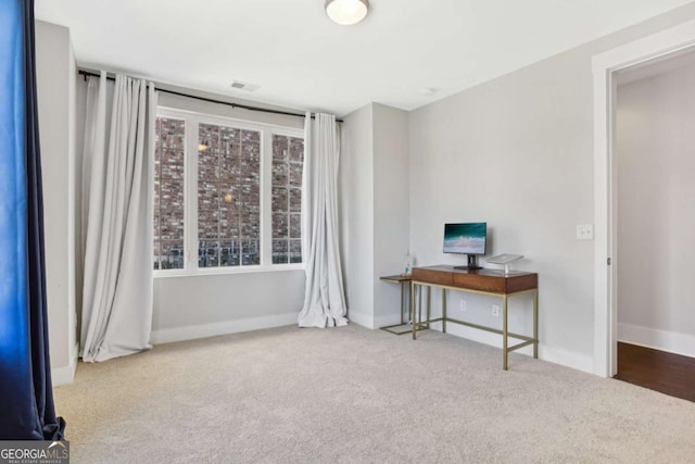 interior space with carpet floors and baseboards