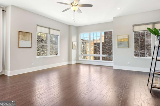 unfurnished living room with dark wood-style floors, baseboards, a ceiling fan, and recessed lighting